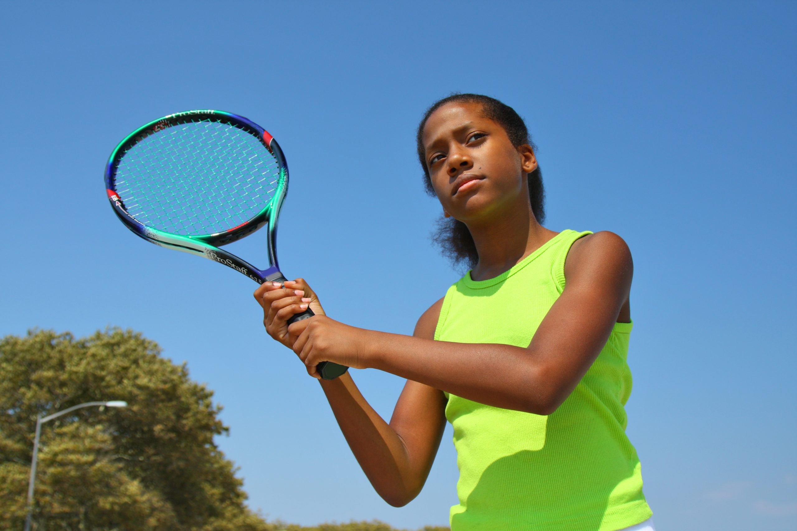13 year old girl playing tennis